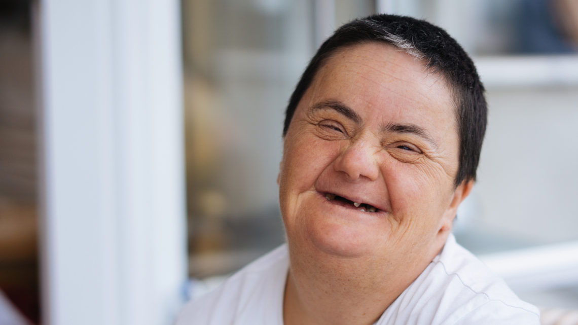 Photo of an older woman smiling in close up