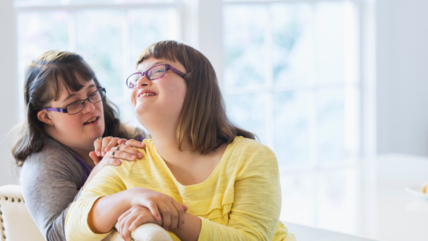 Photo of two young women sitting closely together