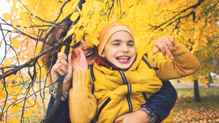 Photo of a woman and child in autumnal woods