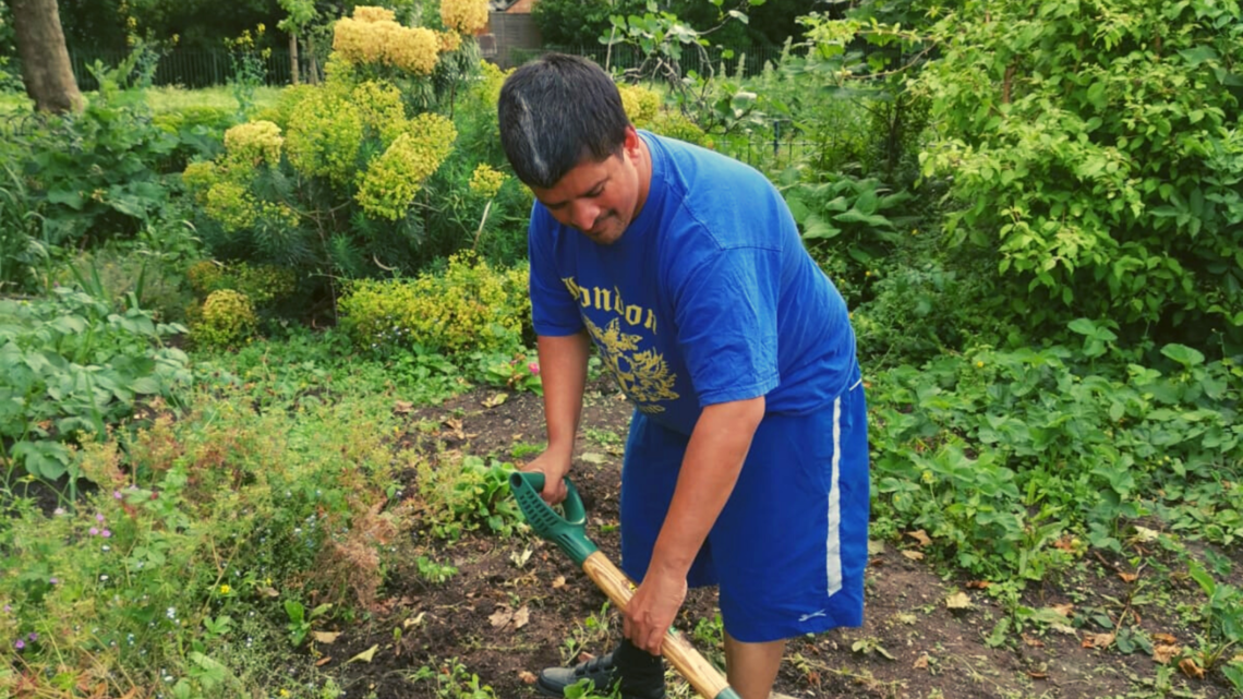 Photo of a young man digging in a garden