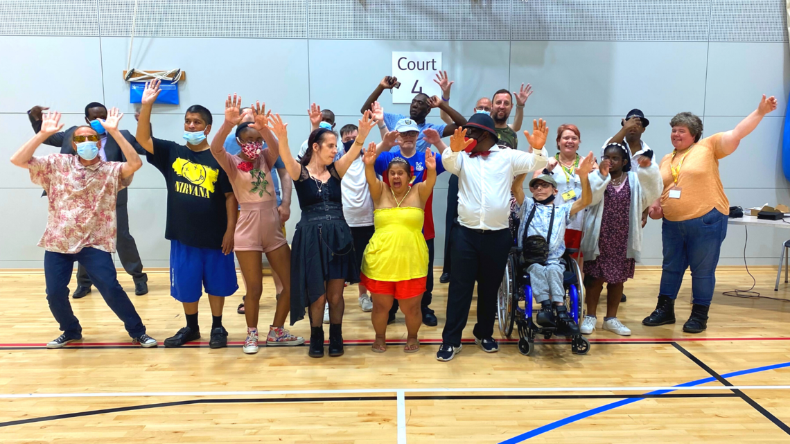 Photo of group of people together in a sports hall